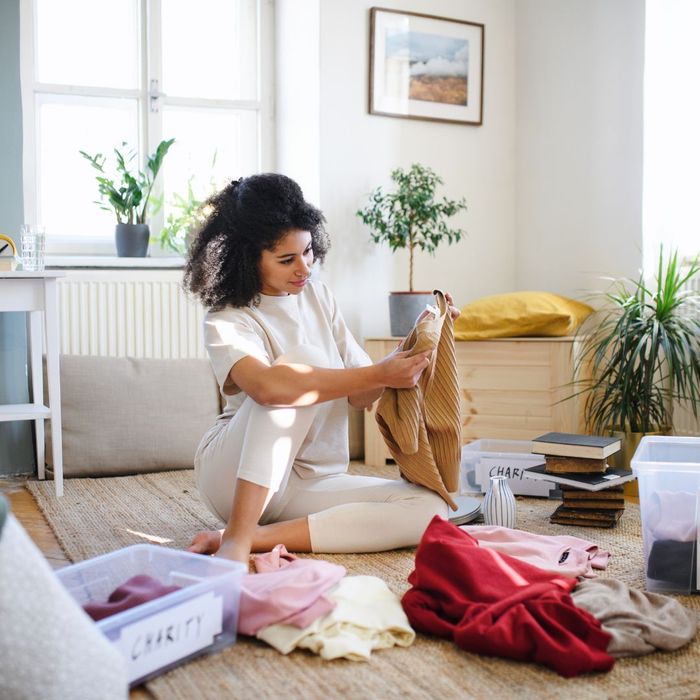 Person sorting clothes and belongings into tubs