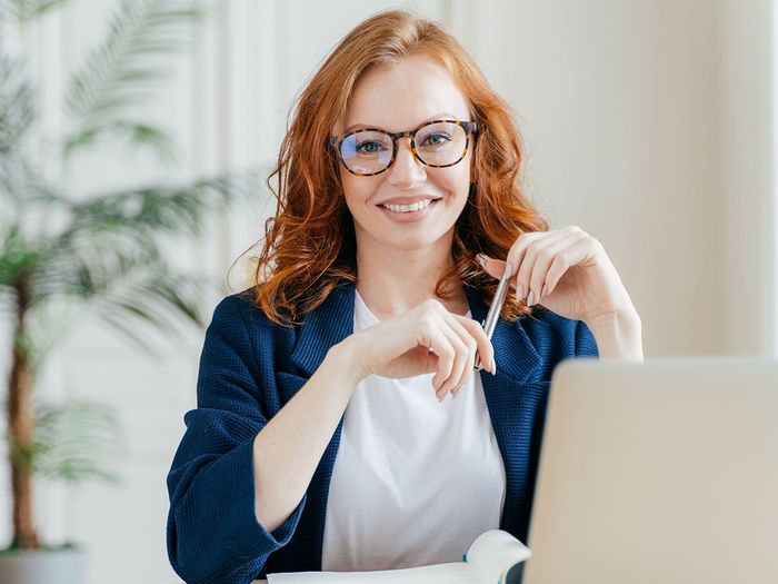 woman smiling behind desk