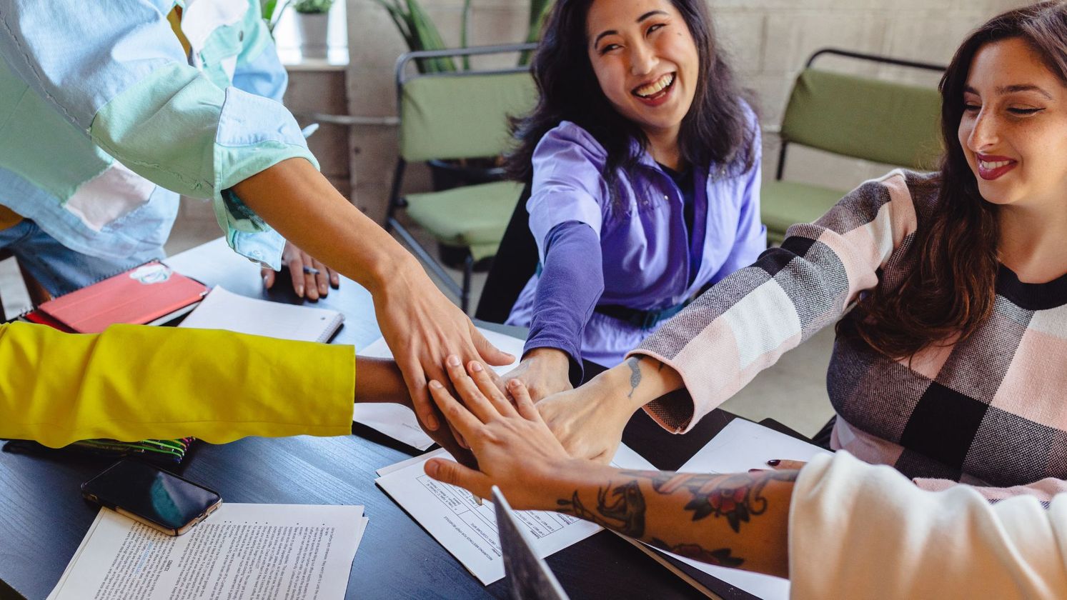 friends/coworkers putting hands together