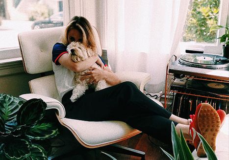 woman and dog sitting on chair