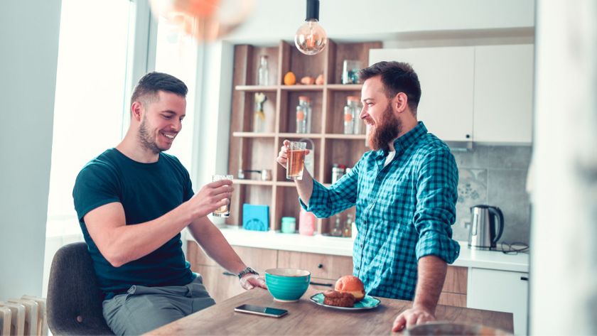 Two people chatting in the kitchen over beers