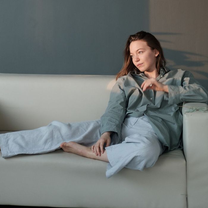 well-dressed woman lounging on couch