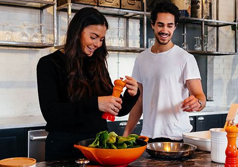 couple making meal in kitchen