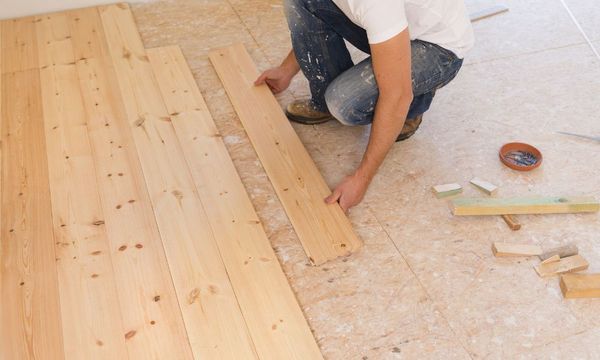 man installing new hardwood floor