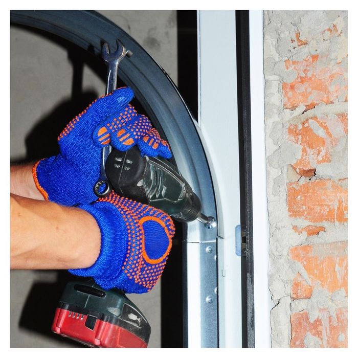 close up of professional installing garage door tract