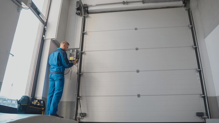 man inspecting garage door