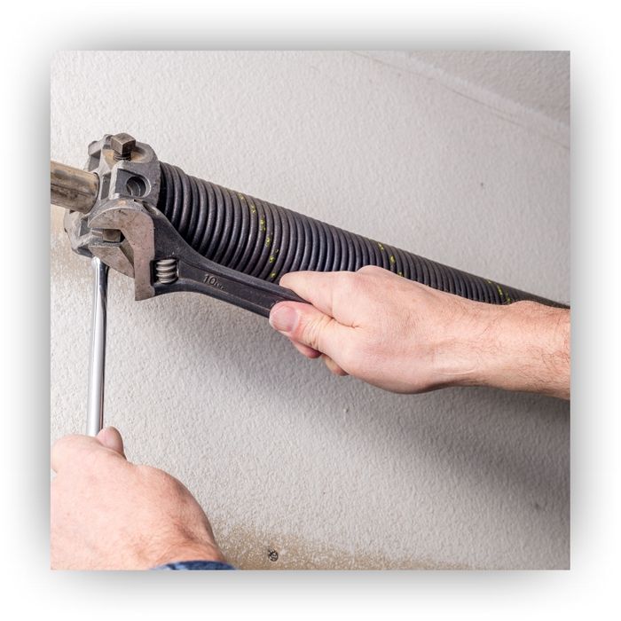 Tightening garage door spring with a wrench