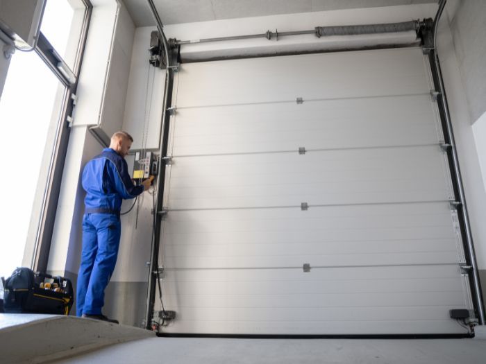 Man repairing a garage door. 