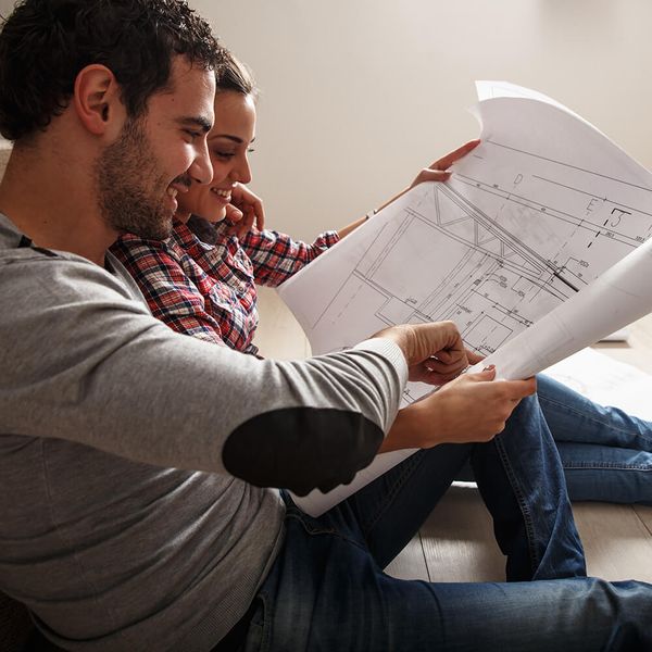 couple looking at blueprints of new house