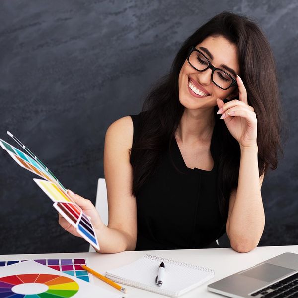 smiling woman looking at color swatches