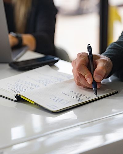 Executive man writing notes in notebook