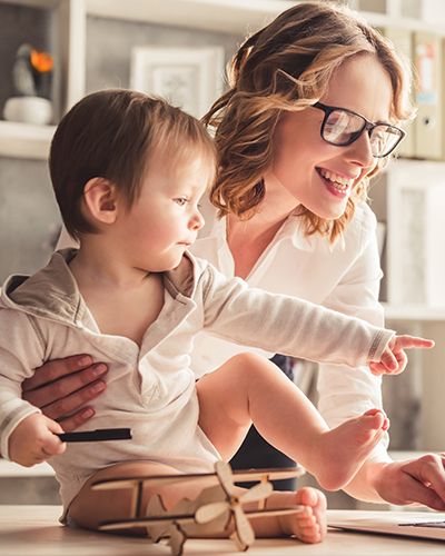 Mother and child with toy looking at information online