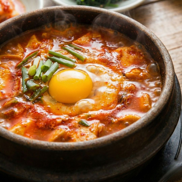 bubbling, spicy Sundubu stew with a raw egg on top