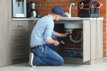 handyman fixing sink