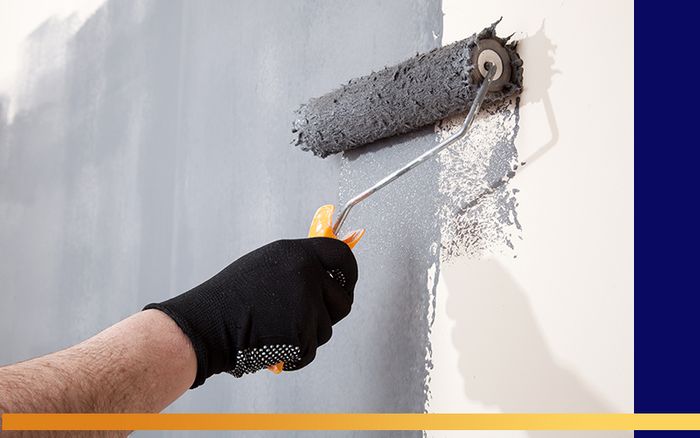 A person painting an interior wall