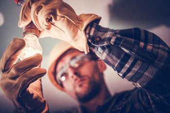 handyman installing lighting fixture