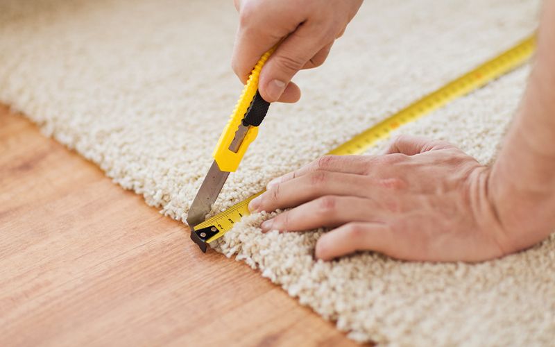 a person removing carpet