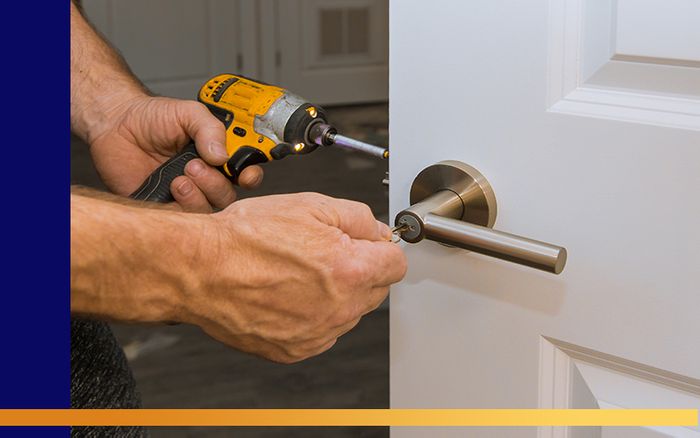 image of a handyman fixing a door