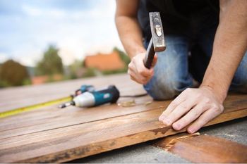 handyman hammering on deck