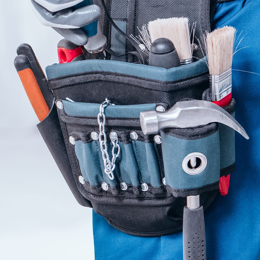 Image of a man wearing a tool belt filled with tools