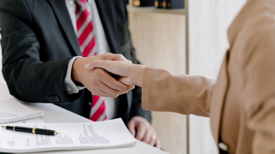 a lawyer shaking hands with a client