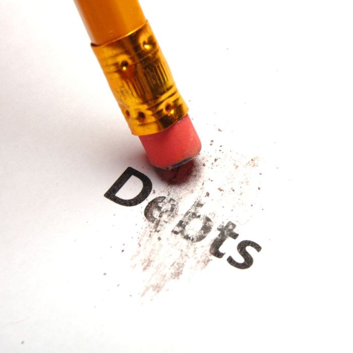 A pencil erasing the word debt on a piece of paper