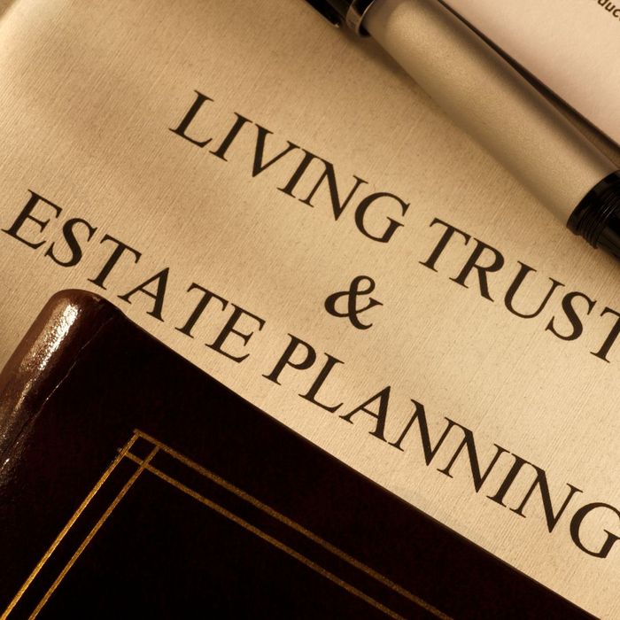 A piece of paper that says LIVING TRUST AND ESTATE PLANNING with a book over the bottom