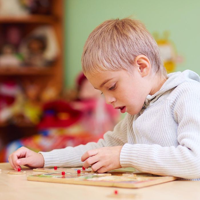 a boy with special needs working on a puzzle