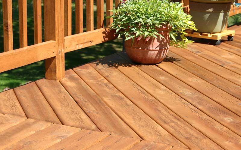 pine colored deck with decorative plants