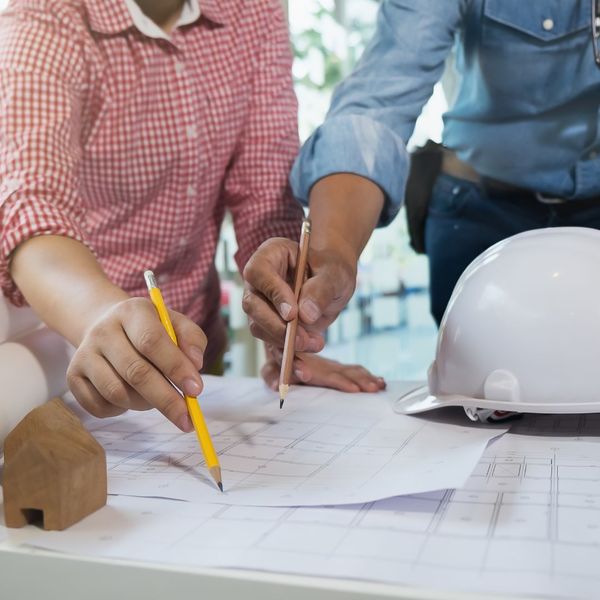 people looking over blueprints How Armstrong Lumber Helps Bring Your Ideas to Life (2).jpg