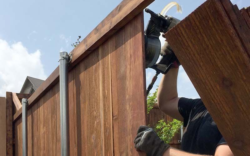  new wooden fence being built in back yard