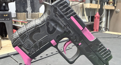 a black and pink gun with cheetah cerakote