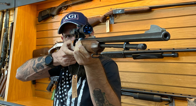 a man pointing a rifle
