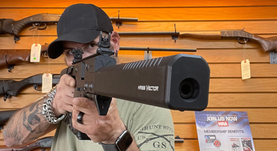 a man looking through the scope of a gun 