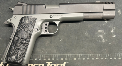 a silver gun with a black skeleton detail