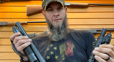 a man holding parts to a gun