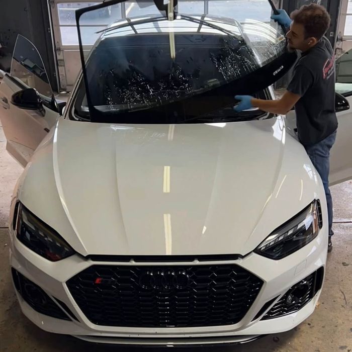 Front windshield being installed