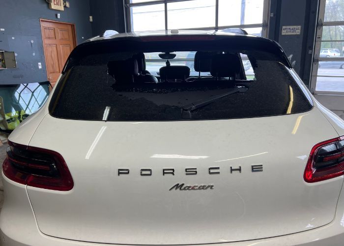 a broken porsche macan back windshield that needs replaced