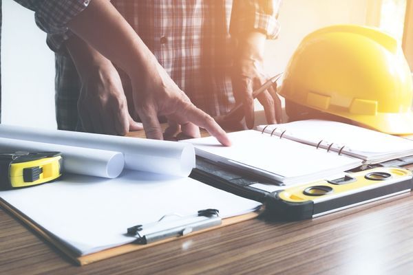 contractor looking at plans for building