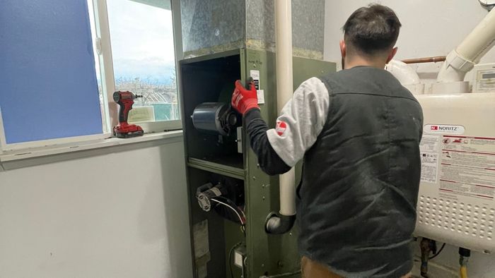 Image of a worker installing a new heating system
