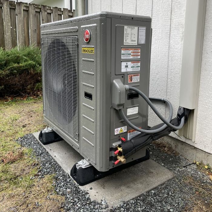 An outdoor AC unit clear of plants and other debris.