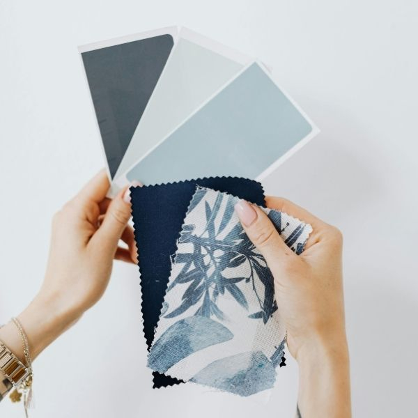 Woman Holding Paper Paint Samples.