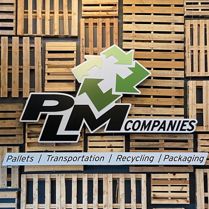 PLM logo with pallets in the background