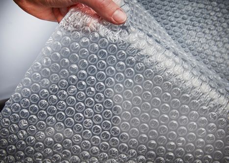 a hand showing a sheet of bubble wrap