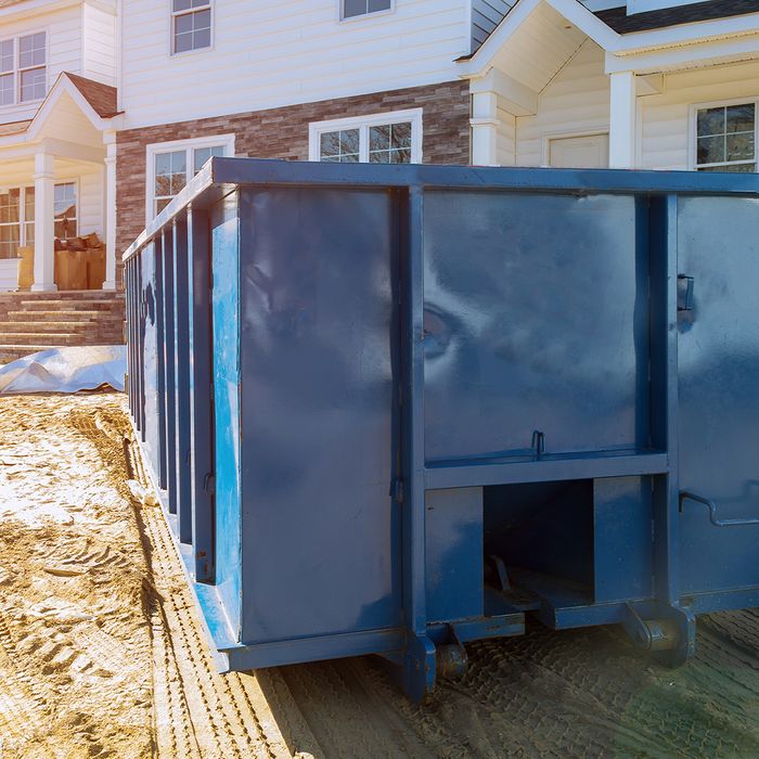 Trash collector outside a house