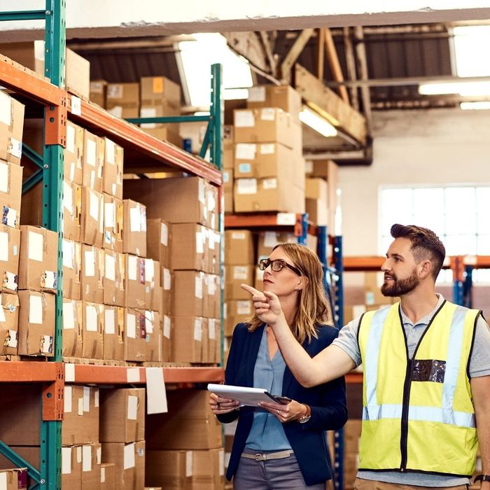 Employees walking around a warehouse.