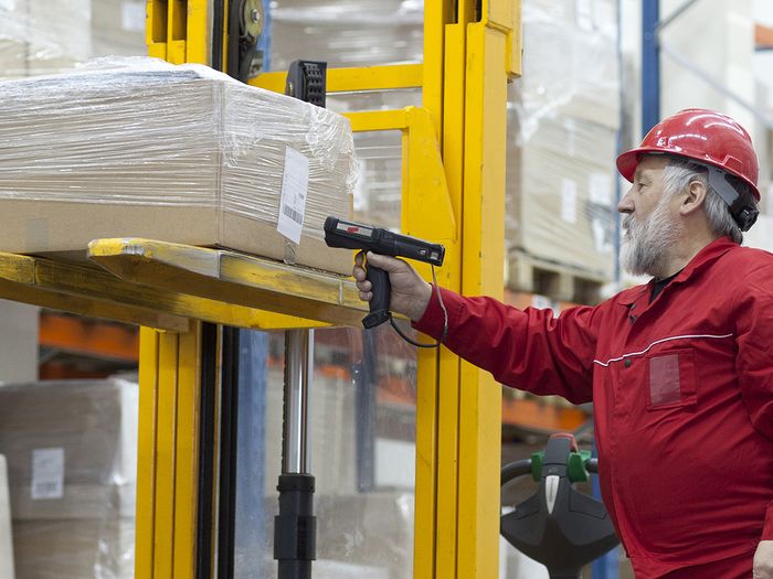 man scanning label on box