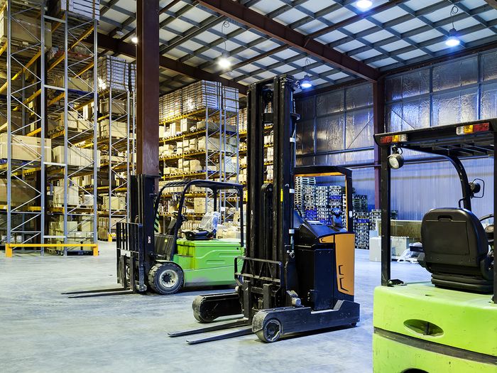 Fleet of forklifts in a warehouse.