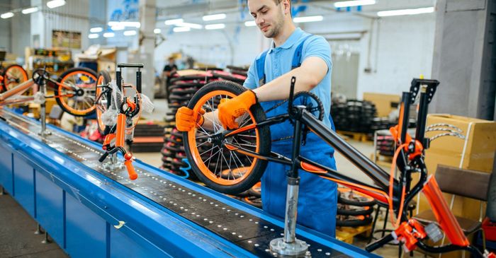 man working on a bicycle assembly line