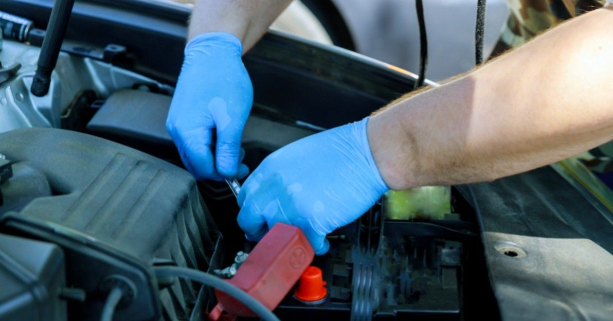 mechanic working on car battery